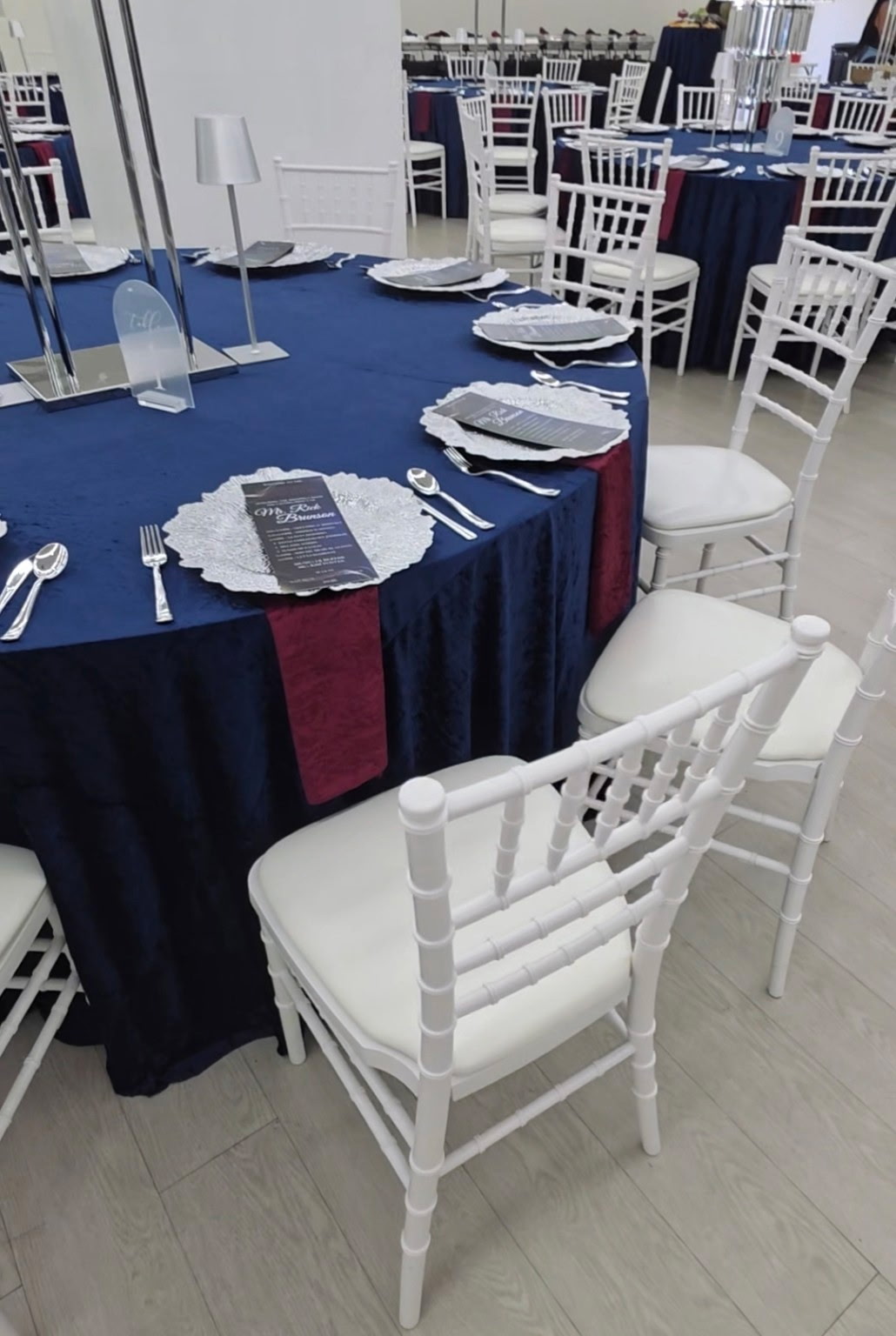 Celebration Hall table decorated with navy linens and elegant place settings
